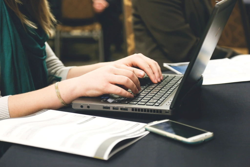 Free woman's hands typing laptop