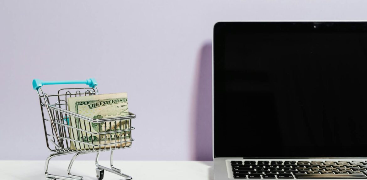 shopping cart next to a laptop